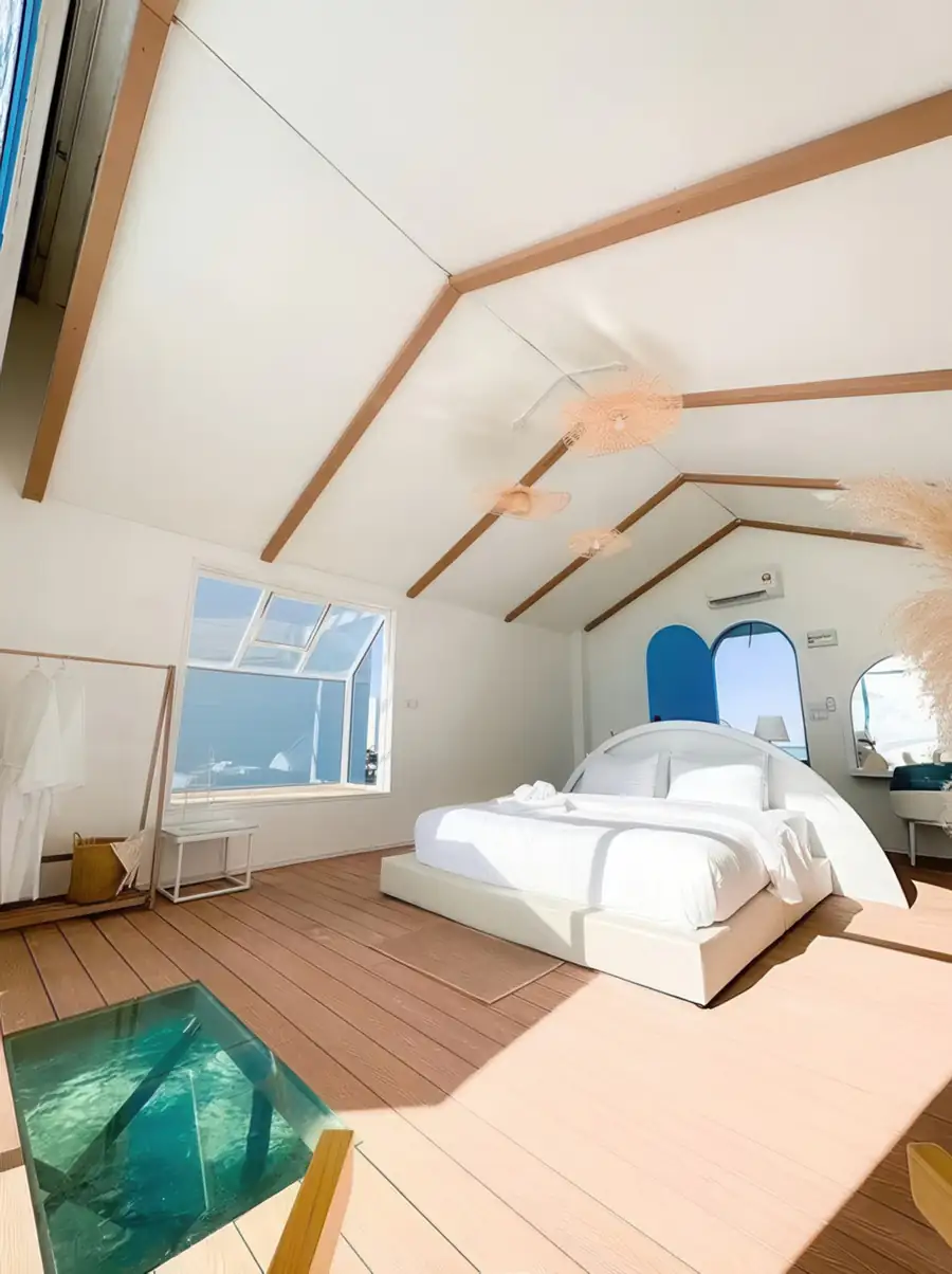 Glass floor panel beside bed in Couple Suite Royal Resort Semporna
