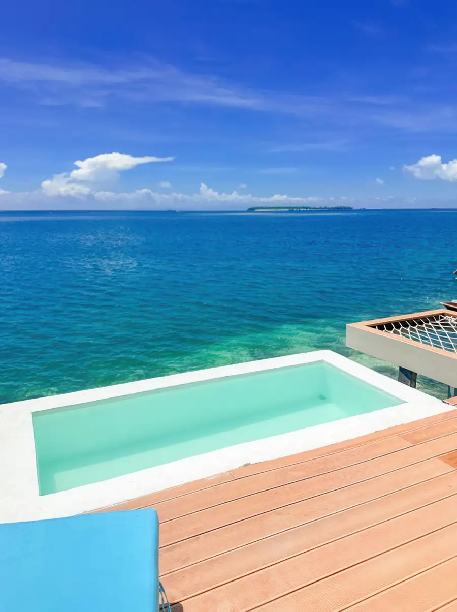 Blue sun lounger on pool deck Family Suite Royal Resort Semporna