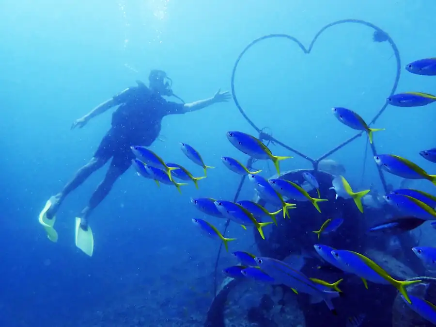 Diver making a heart shape underwater in Tun Sakaran Semporna Royal Resort