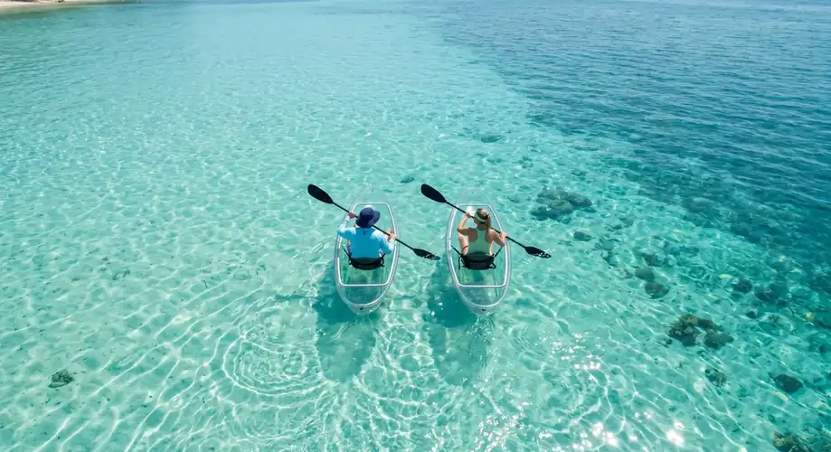 Guest enjoying a kayaking session in the turquoise sea Semporna Royal Resort